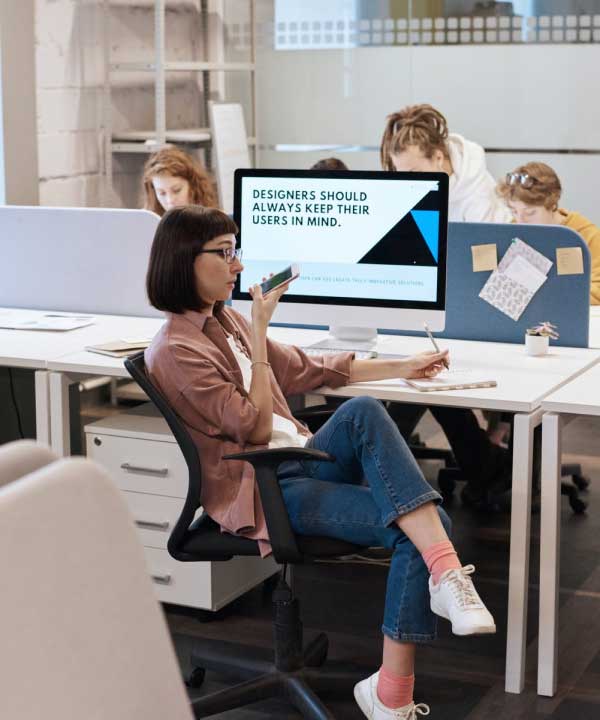 a group of people designing websites in an office